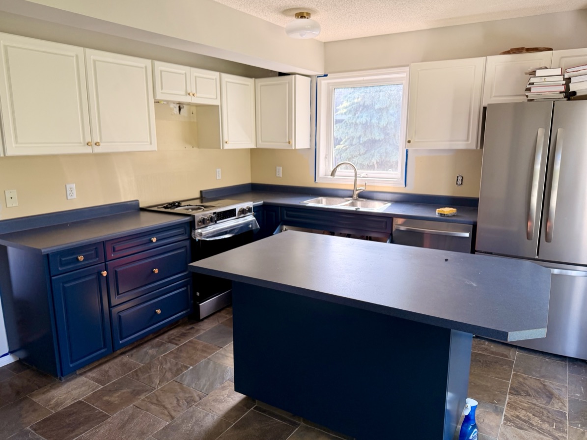 A Calgary kitchen with dark laminate counters, before its new countertop