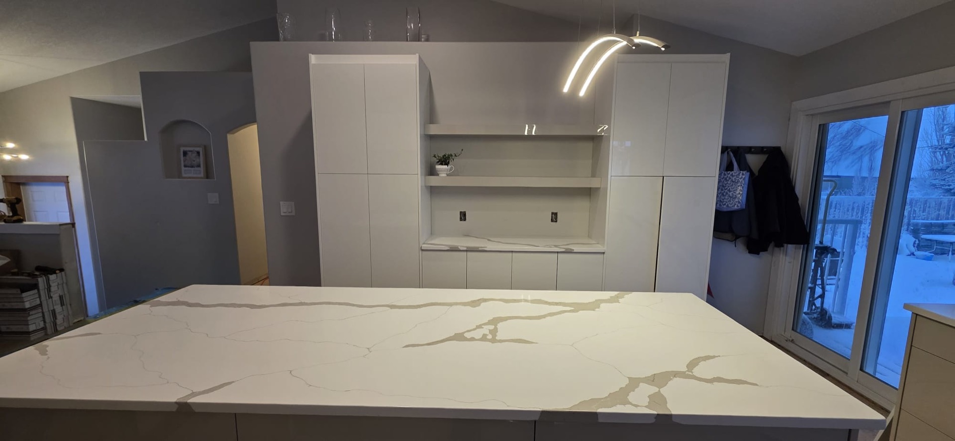 White quartz island countertop installed in a new Airdrie home kitchen