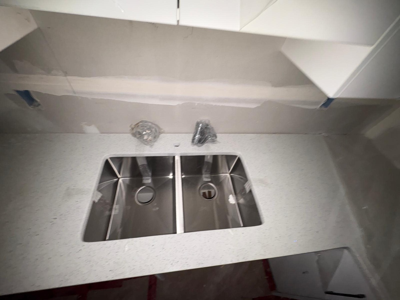 White quartz vanity-style countertop with double undermount sink installed by Bedrock Countertops in Calgary